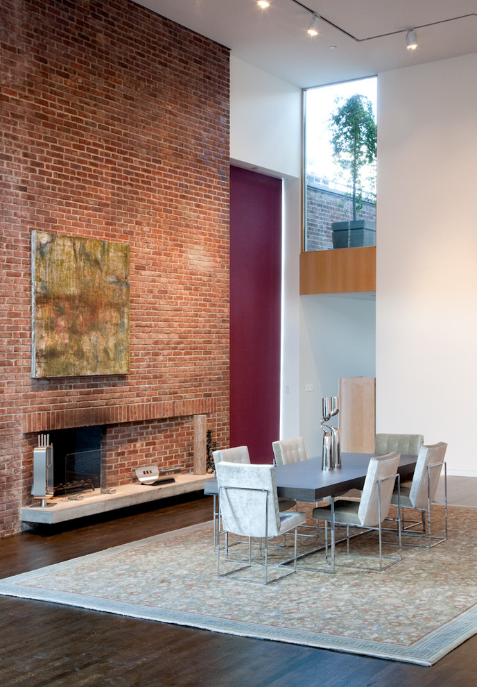 Design ideas for a contemporary dining room in New York with white walls, dark hardwood floors, a standard fireplace and a brick fireplace surround.