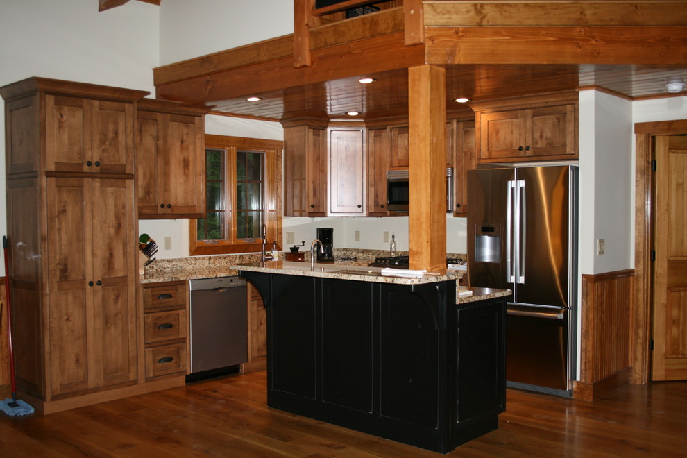 Inspiration for a mid-sized rustic l-shaped dark wood floor eat-in kitchen remodel in Boston with shaker cabinets, medium tone wood cabinets, granite countertops, stainless steel appliances and an island