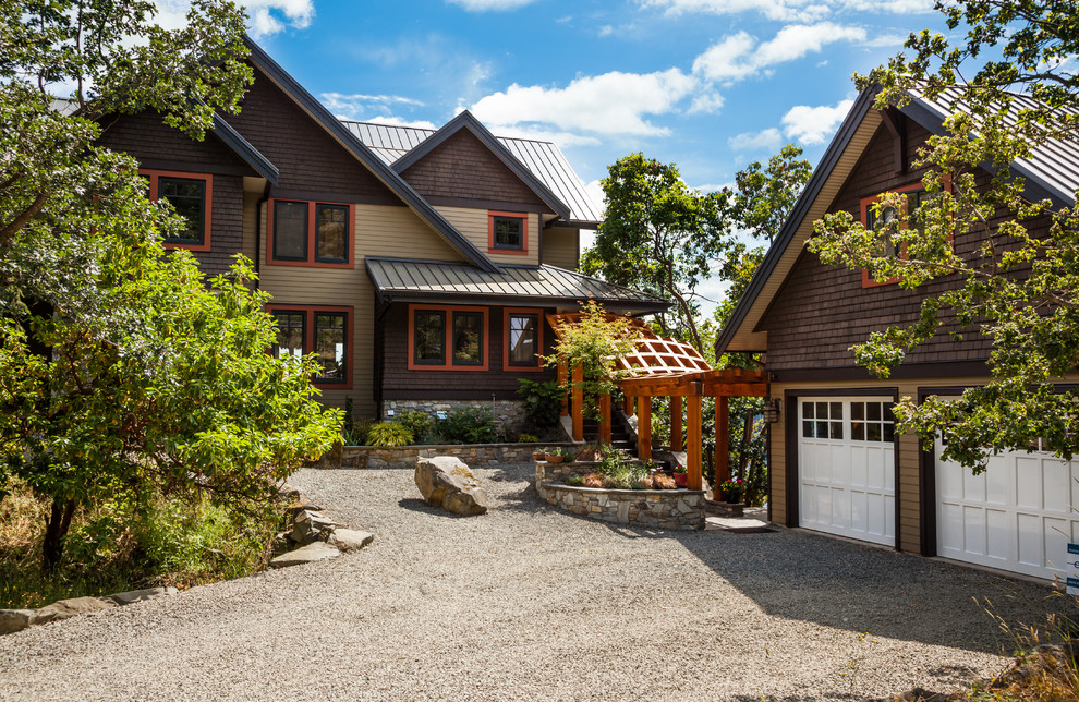 Inspiration for a large rustic brown two-story wood gable roof remodel with a metal roof and a pergola