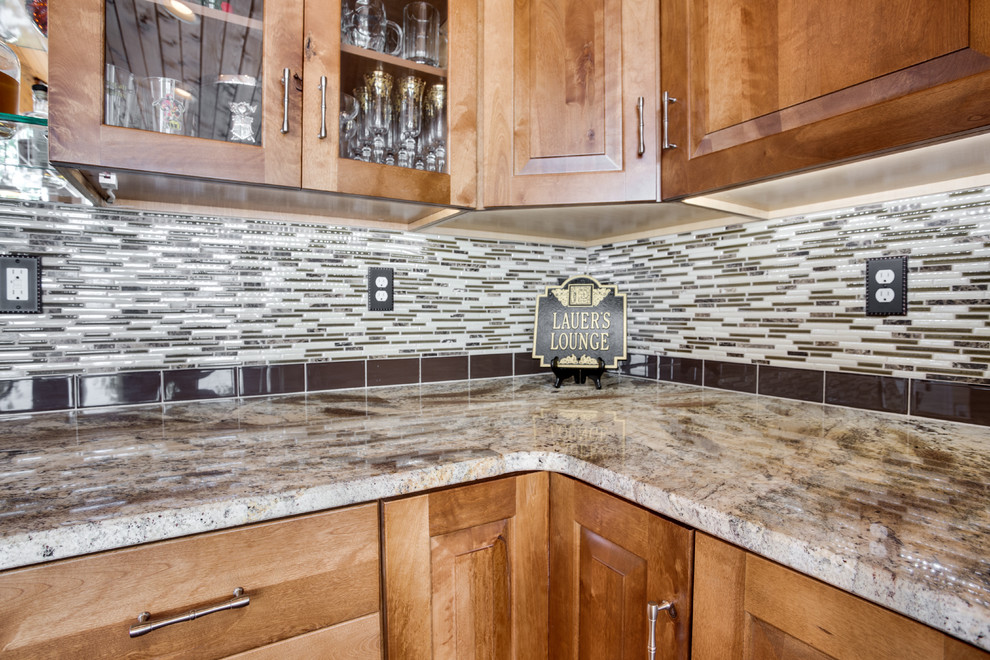 Inspiration for a large rustic kitchen remodel in DC Metro with an undermount sink, raised-panel cabinets, granite countertops, glass tile backsplash, stainless steel appliances and an island
