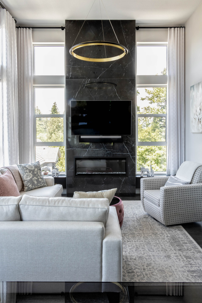 Inspiration for a mid-sized modern open concept living room in Vancouver with white walls, dark hardwood floors, a stone fireplace surround, a wall-mounted tv and white floor.