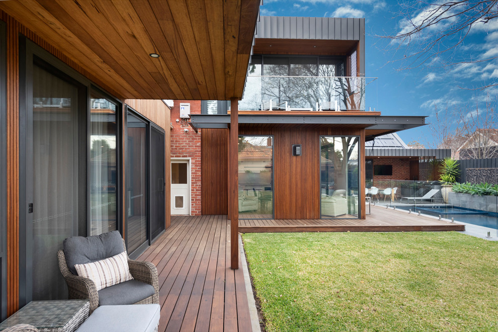 Mid-sized contemporary backyard deck in Melbourne with a pergola.