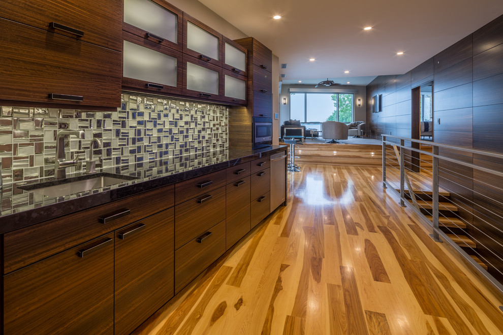 This is an example of a large contemporary kitchen in Other with bamboo floors.