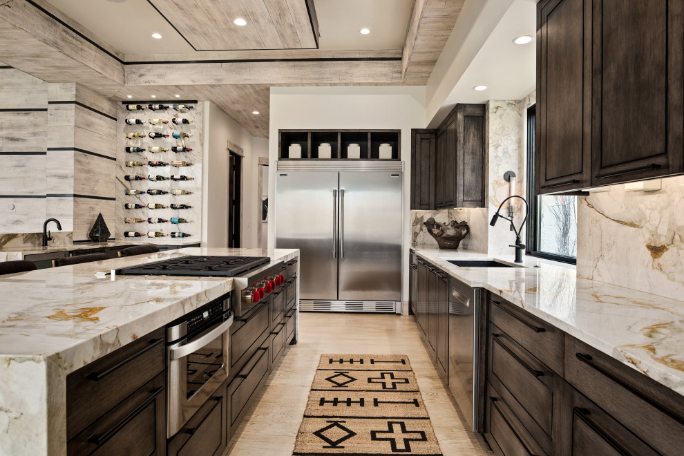 Design ideas for a transitional l-shaped open plan kitchen in Kansas City with an undermount sink, raised-panel cabinets, dark wood cabinets, multi-coloured splashback, stainless steel appliances, light hardwood floors, with island, beige floor and multi-coloured benchtop.