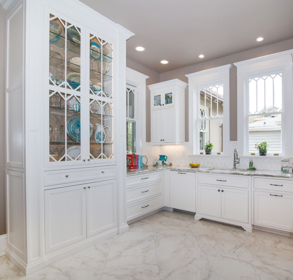 Inspiration for a mid-sized transitional u-shaped kitchen in Charlotte with a single-bowl sink, beaded inset cabinets, white cabinets, quartzite benchtops, white splashback, stainless steel appliances, with island and white floor.
