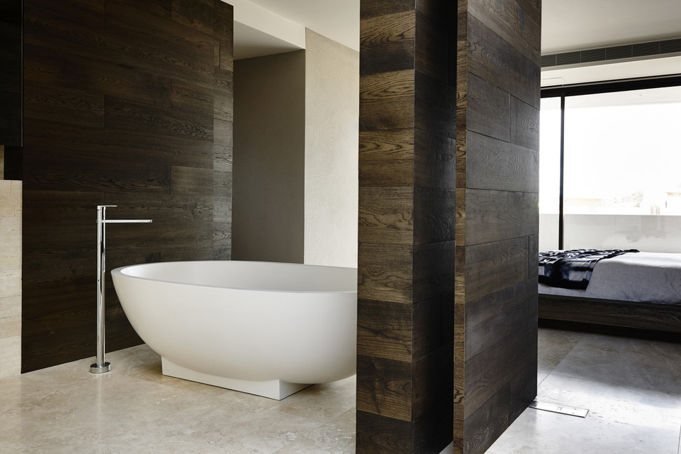 Contemporary bathroom in Melbourne with limestone floors.