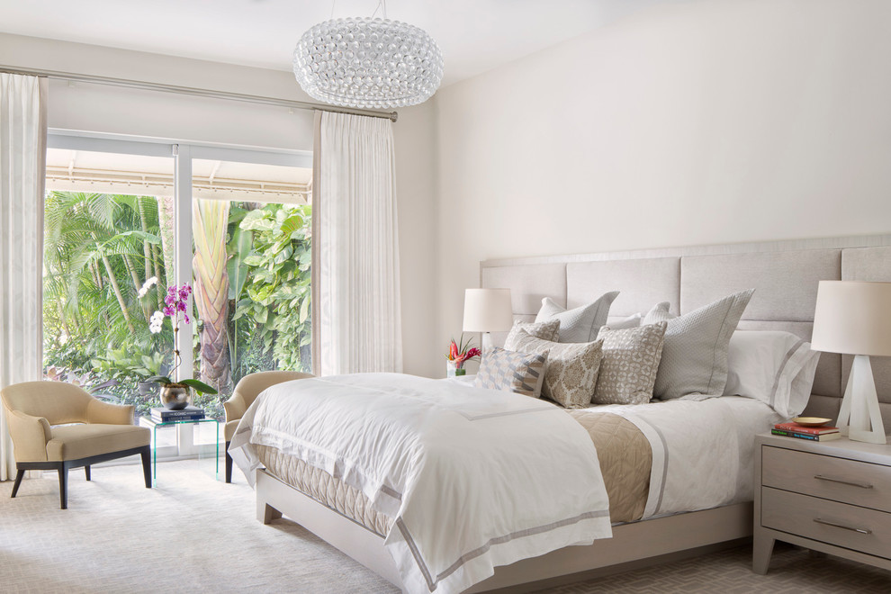 Inspiration for a large transitional master bedroom in Miami with grey walls and carpet.