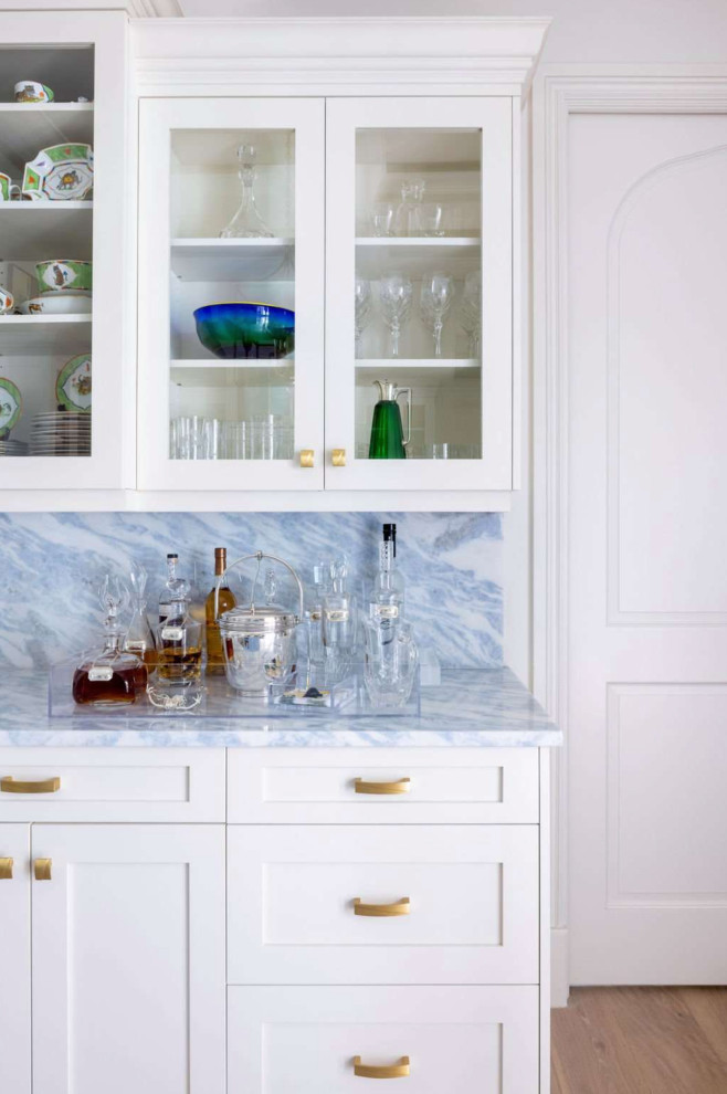 Large transitional home bar in Other with glass-front cabinets, white cabinets, marble benchtops, blue splashback, marble splashback and blue benchtop.