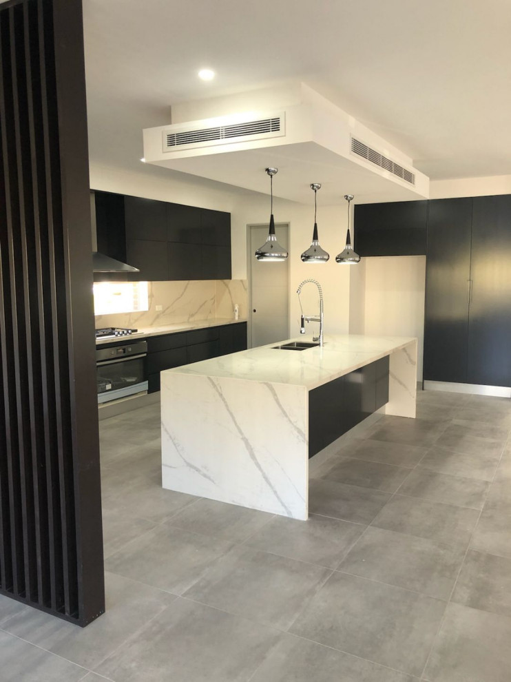 This is an example of a large contemporary l-shaped eat-in kitchen in Sydney with an undermount sink, grey cabinets, quartz benchtops, white splashback, marble splashback, stainless steel appliances, bamboo floors, with island and white benchtop.