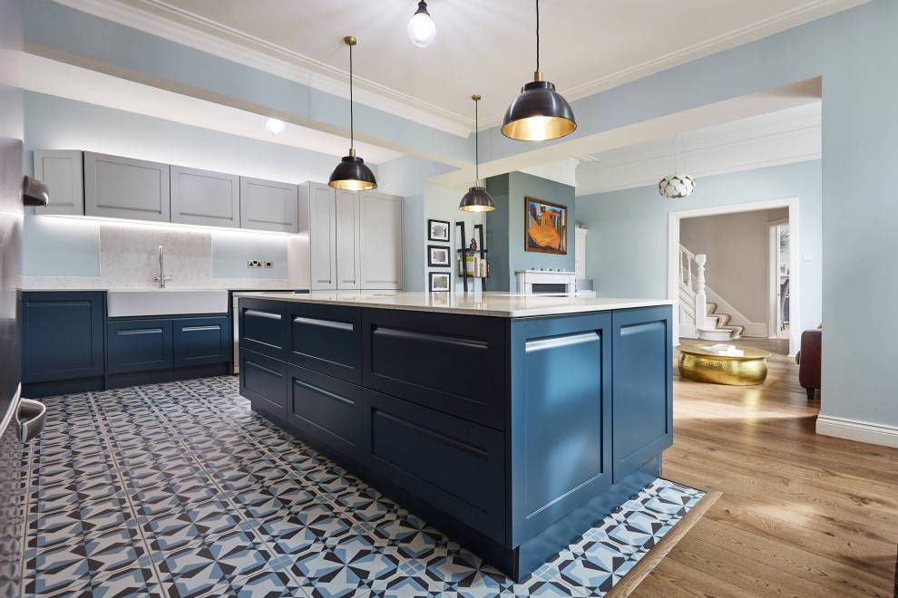 Design ideas for a mid-sized l-shaped eat-in kitchen in Other with a farmhouse sink, shaker cabinets, blue cabinets, marble benchtops, white splashback, marble splashback, stainless steel appliances, porcelain floors, multiple islands, blue floor, white benchtop and coffered.