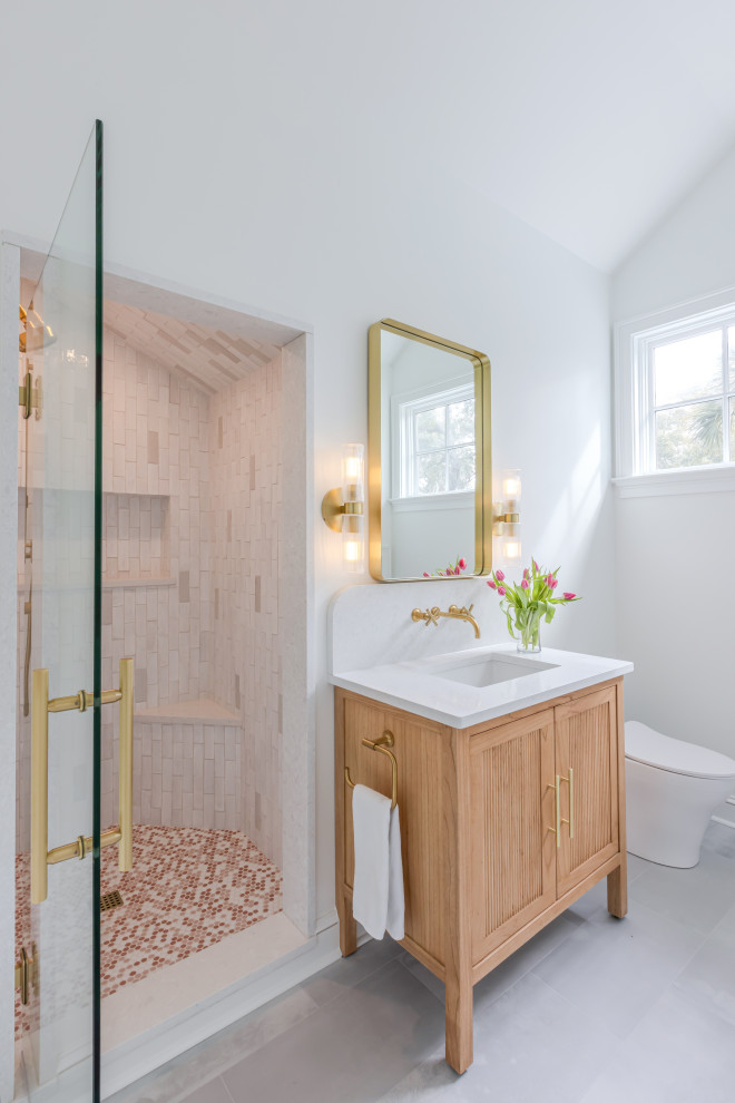 Inspiration for a mid-sized transitional kids' pink tile and terra-cotta tile ceramic tile, gray floor, single-sink and vaulted ceiling alcove shower remodel in Charleston with beaded inset cabinets, light wood cabinets, a two-piece toilet, white walls, an undermount sink, quartz countertops, a hinged shower door, white countertops, a niche and a freestanding vanity