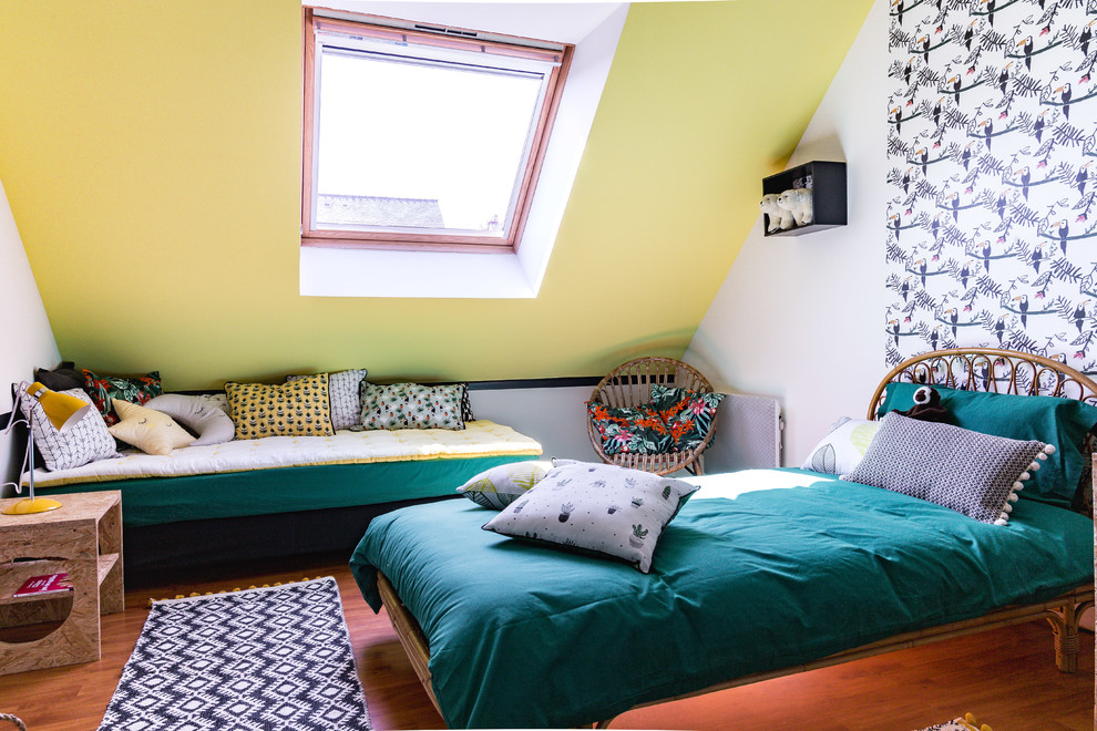 Photo of a mid-sized contemporary gender-neutral kids' room for kids 4-10 years old in Paris with yellow walls, dark hardwood floors and brown floor.