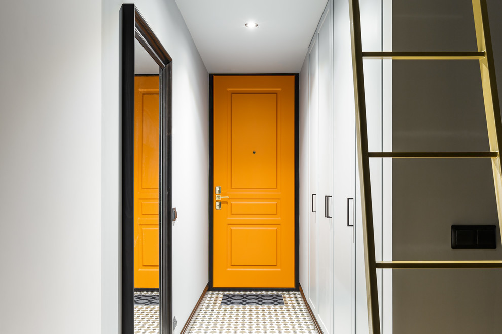 This is an example of a small contemporary entry hall in Saint Petersburg with grey walls, ceramic floors, multi-coloured floor, a single front door and an orange front door.