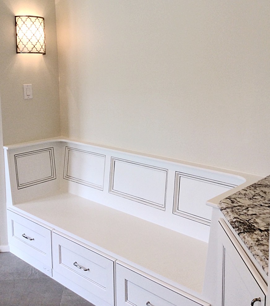 Inspiration for a mid-sized transitional u-shaped ceramic tile eat-in kitchen remodel in Houston with a farmhouse sink, recessed-panel cabinets, white cabinets, granite countertops, white backsplash, stone tile backsplash, stainless steel appliances and an island