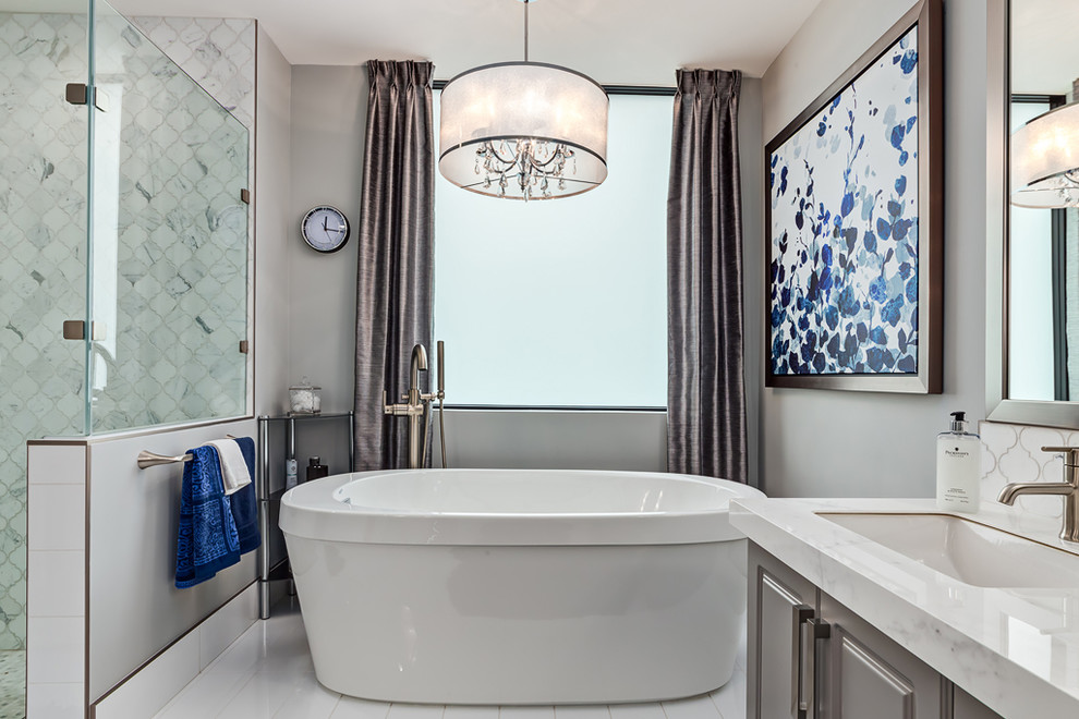 Design ideas for a transitional master bathroom in Calgary with a freestanding tub, shaker cabinets, grey cabinets, a corner shower, white tile, ceramic tile, grey walls, ceramic floors, an undermount sink and granite benchtops.