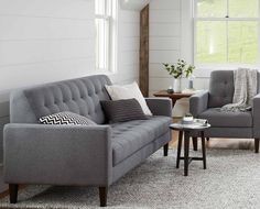 This is an example of a medium sized farmhouse open plan living room in Portland with white walls, light hardwood flooring and beige floors.