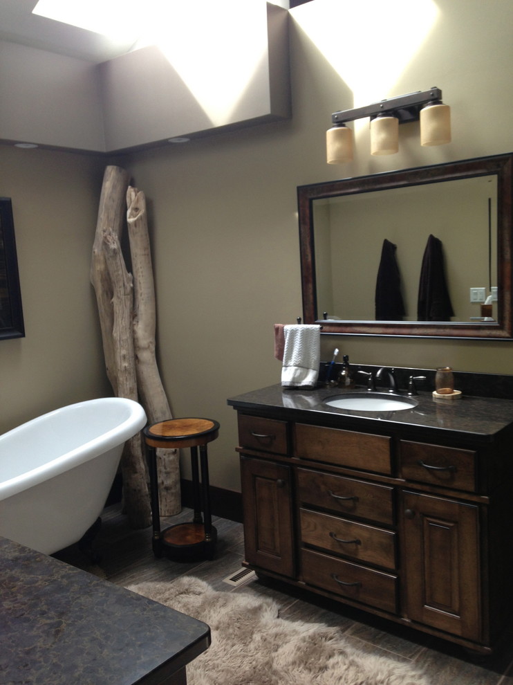 Inspiration for a mid-sized country 3/4 bathroom in Other with flat-panel cabinets, dark wood cabinets, a freestanding tub, an open shower, a one-piece toilet, black tile, stone slab, blue walls, dark hardwood floors, a pedestal sink and solid surface benchtops.