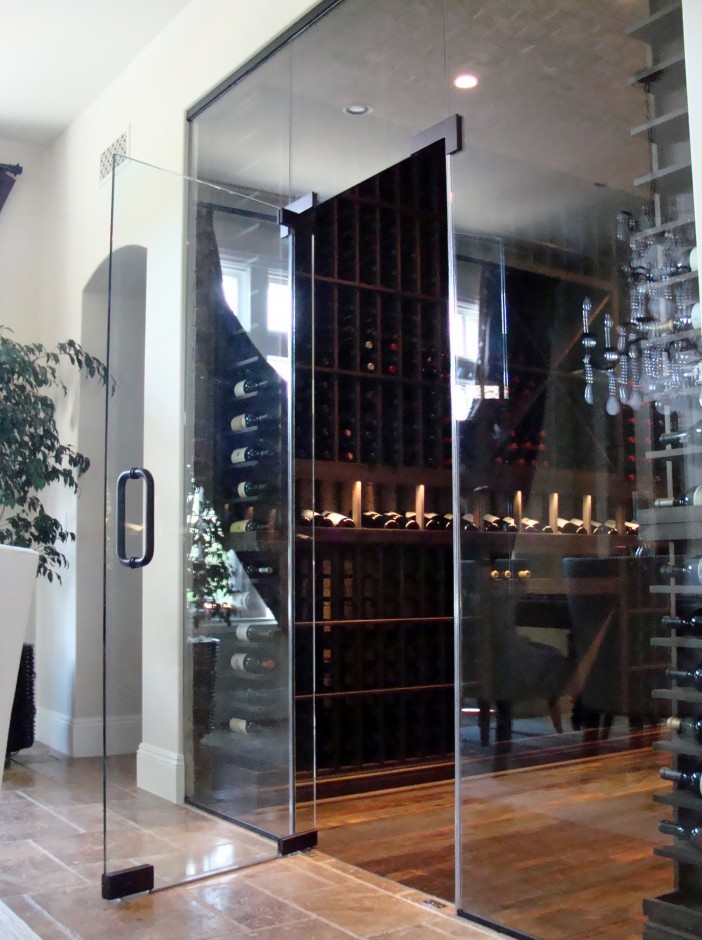 Mid-sized contemporary wine cellar in Orange County with medium hardwood floors and storage racks.