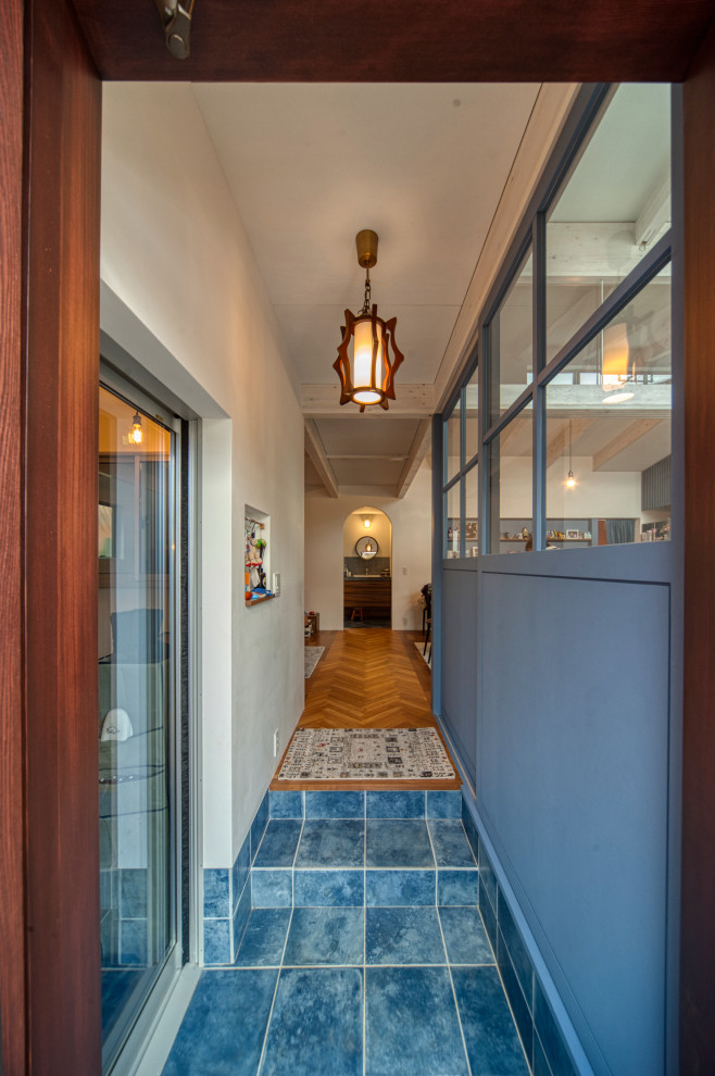 Small mediterranean entryway in Other with purple walls, ceramic floors and turquoise floor.