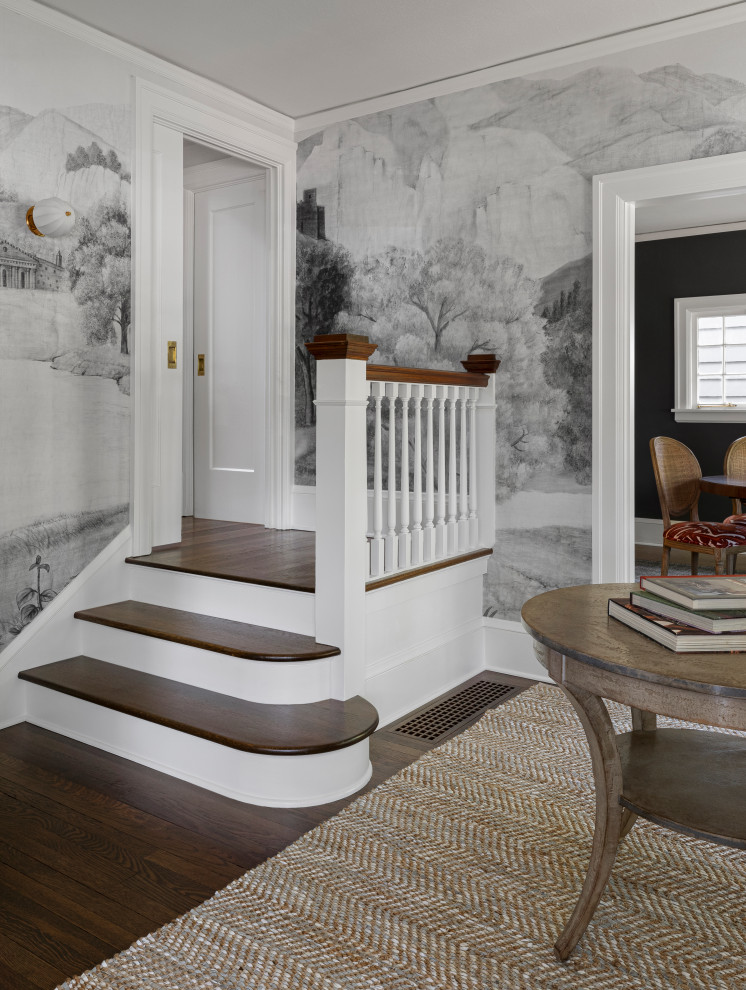 This is an example of a large transitional foyer in Portland with multi-coloured walls, dark hardwood floors, a single front door, a white front door, brown floor and wallpaper.