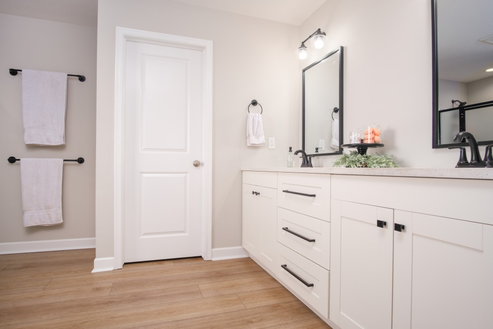 Large cottage master vinyl floor, brown floor, double-sink and vaulted ceiling bathroom photo in Columbus with beaded inset cabinets, white cabinets, a one-piece toilet, gray walls, a drop-in sink, marble countertops, white countertops and a built-in vanity