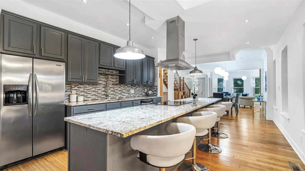 Design ideas for a large modern galley eat-in kitchen in St Louis with a drop-in sink, shaker cabinets, grey cabinets, granite benchtops, multi-coloured splashback, shiplap splashback, stainless steel appliances, light hardwood floors, with island, brown floor, grey benchtop and vaulted.