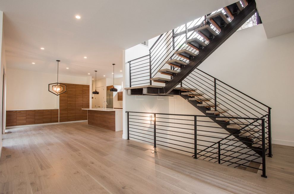 Design ideas for a mid-sized modern wood u-shaped staircase in Denver with open risers and metal railing.