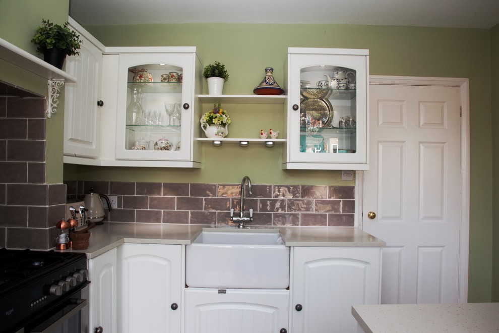 Photo of a mid-sized country l-shaped eat-in kitchen in Berkshire with a farmhouse sink and with island.