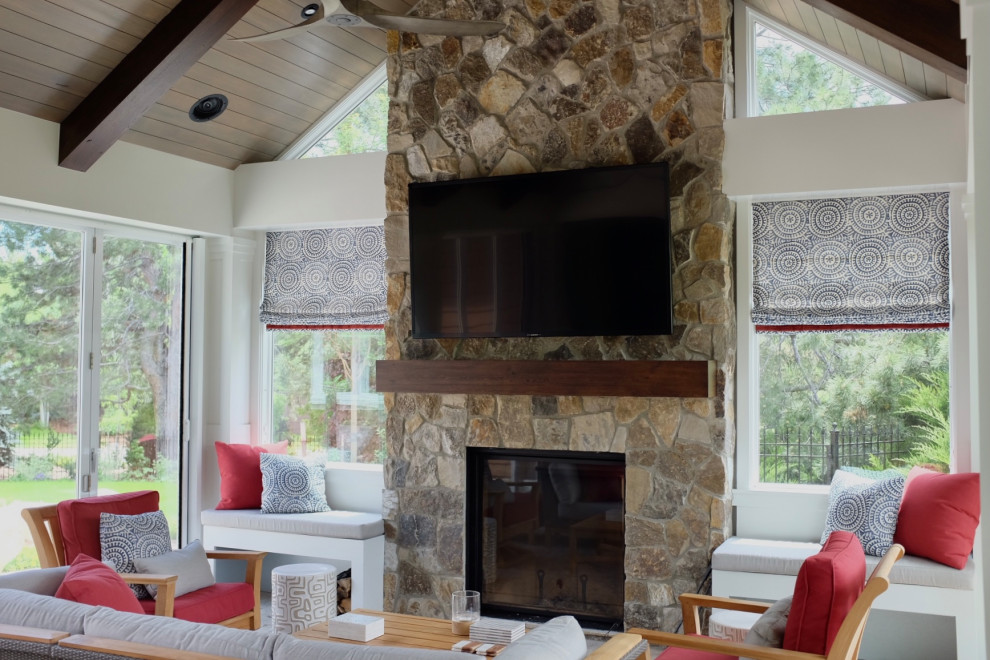 Inspiration for a timeless slate floor sunroom remodel in Denver with a standard fireplace and a stone fireplace