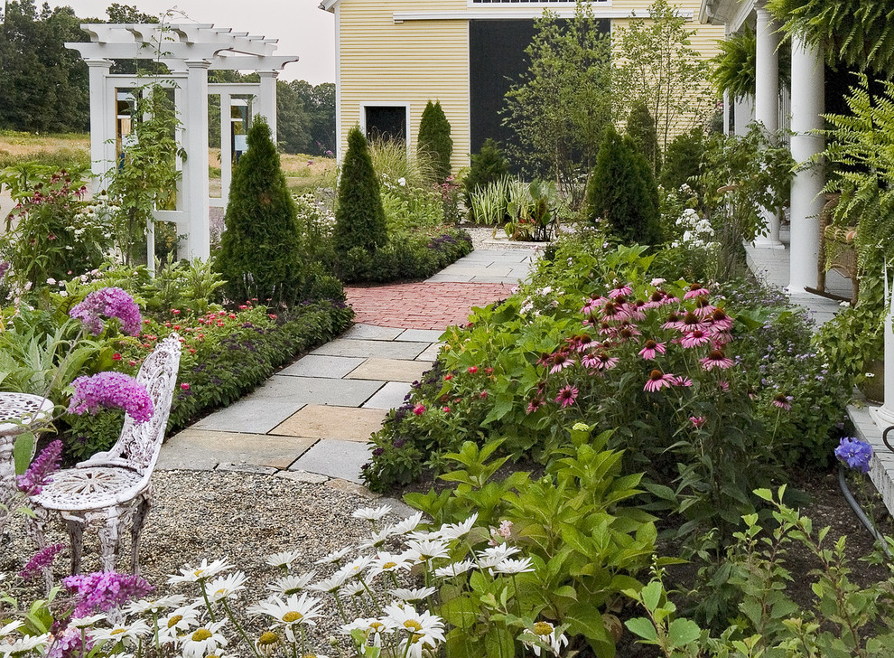 Inspiration for a mid-sized transitional courtyard full sun garden in Portland Maine with a vegetable garden and natural stone pavers.