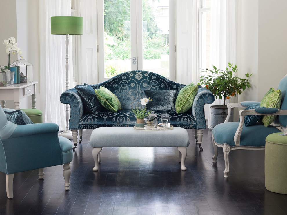 This is an example of a large traditional formal enclosed living room in Hampshire with white walls, dark hardwood floors, no fireplace and no tv.