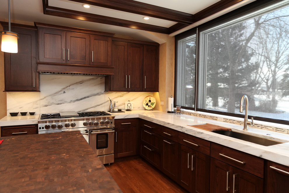 Example of a transitional medium tone wood floor kitchen design in Chicago with an undermount sink, shaker cabinets, dark wood cabinets, wood countertops, multicolored backsplash, ceramic backsplash and stainless steel appliances