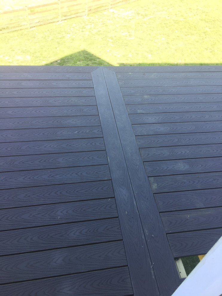 Large backyard second story cable railing deck photo in Baltimore