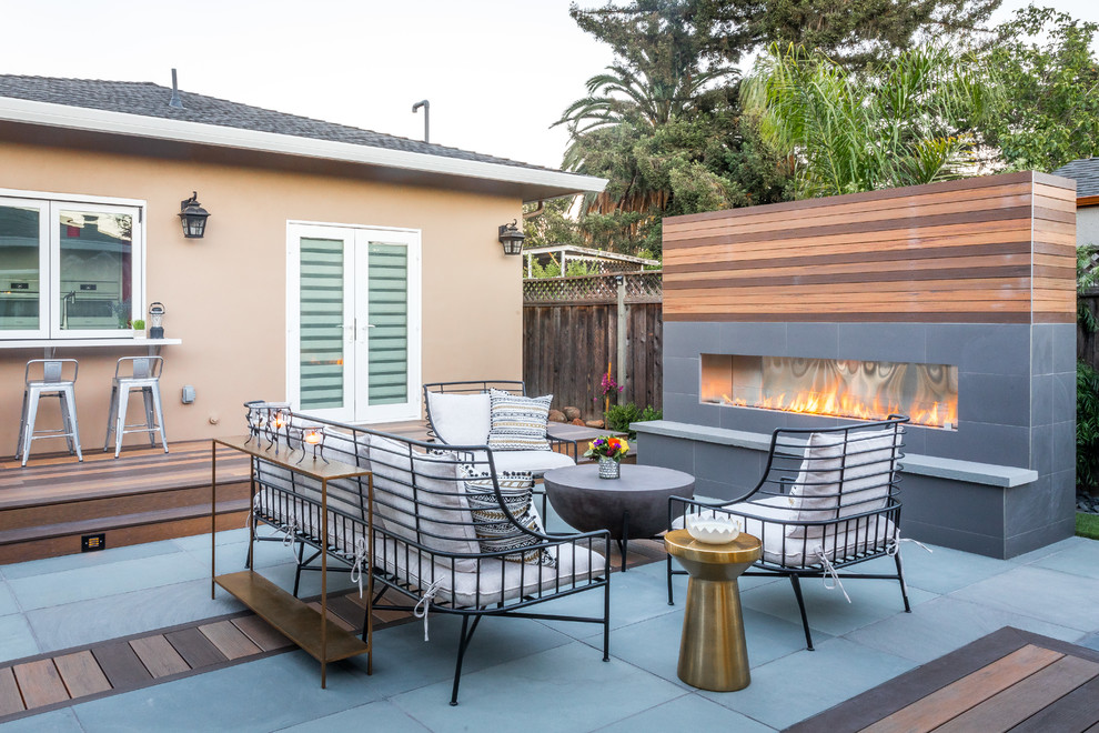 Design ideas for a mid-sized contemporary backyard patio in Richmond with with fireplace, no cover and natural stone pavers.