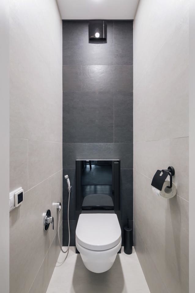 This is an example of a small contemporary powder room in Other with a wall-mount toilet, black and white tile, porcelain tile, grey walls, porcelain floors and white floor.