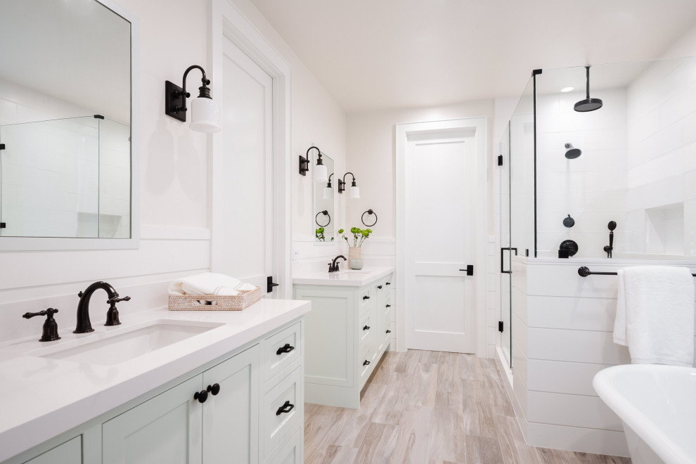 Photo of a large country master bathroom in San Diego with furniture-like cabinets, green cabinets, a freestanding tub, a corner shower, white tile, wood-look tile, white walls, porcelain floors, an undermount sink, engineered quartz benchtops, beige floor, a hinged shower door, white benchtops, a single vanity, a built-in vanity and planked wall panelling.