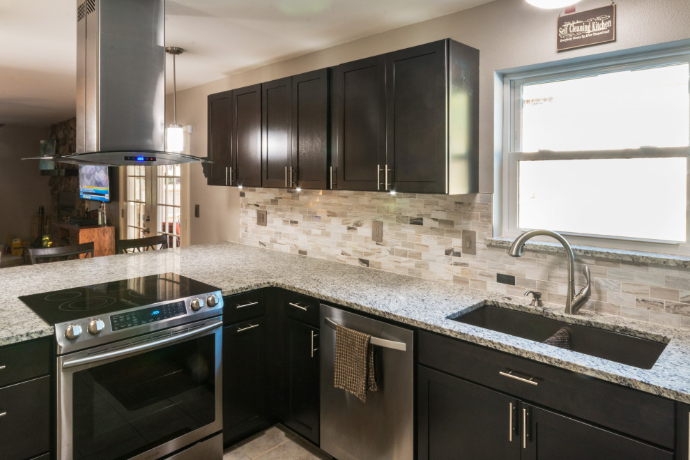 Example of a mid-sized u-shaped ceramic tile and beige floor eat-in kitchen design with an undermount sink, shaker cabinets, black cabinets, granite countertops, glass tile backsplash, stainless steel appliances, an island and white countertops