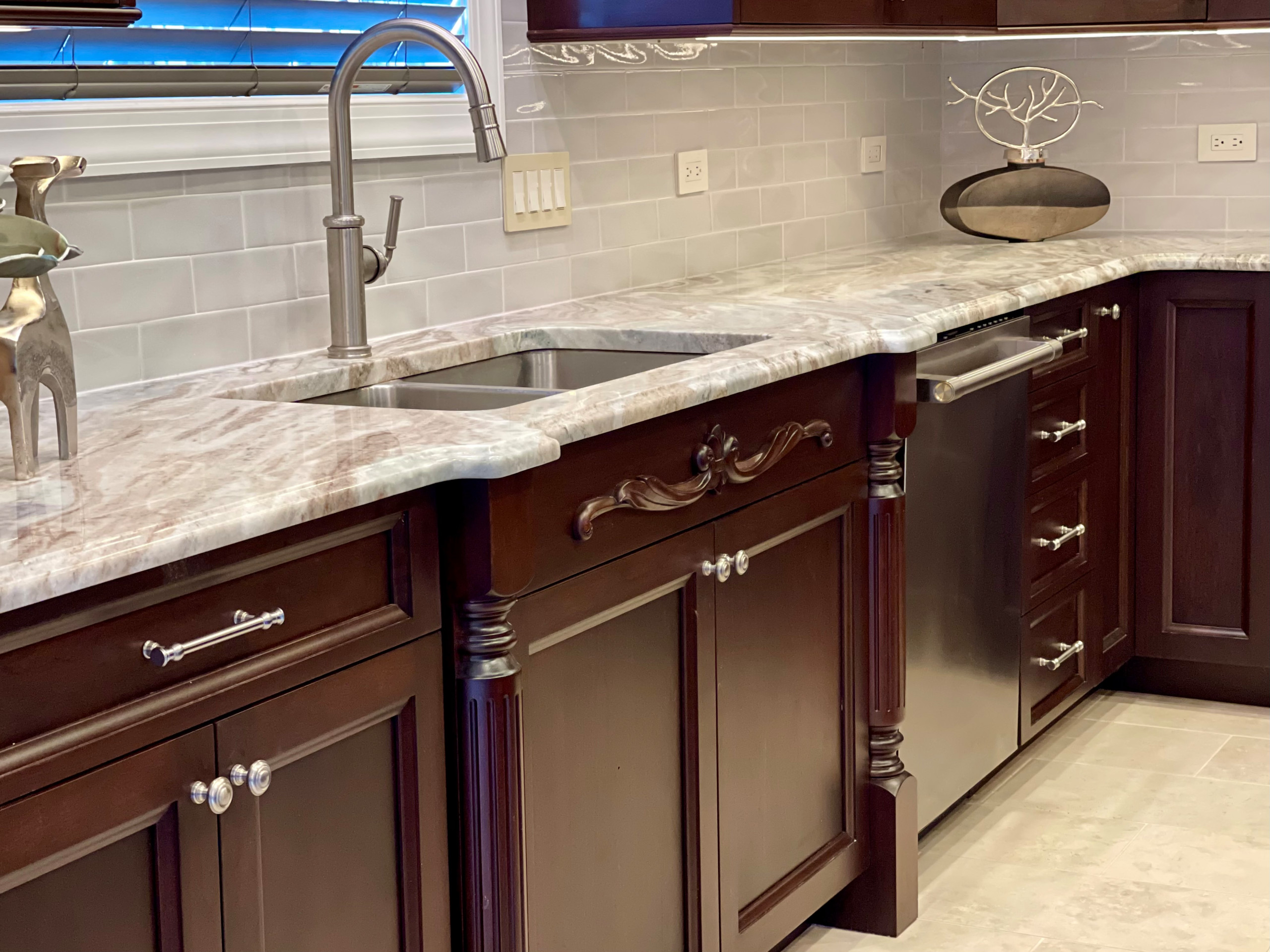 Large elegant porcelain tile and beige floor eat-in kitchen photo in Philadelphia with a double-bowl sink, flat-panel cabinets, brown cabinets, granite countertops, gray backsplash, glass tile backspl