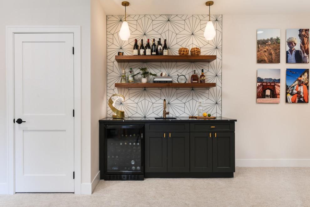 Photo of a home bar in Chicago with black cabinets, quartz benchtops, yellow splashback, cement tile splashback and black benchtop.
