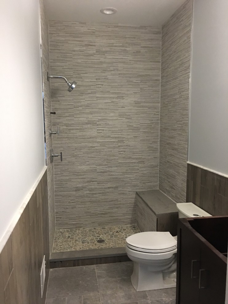 Mid-sized transitional 3/4 gray tile and matchstick tile porcelain tile alcove shower photo in Newark with a two-piece toilet and white walls