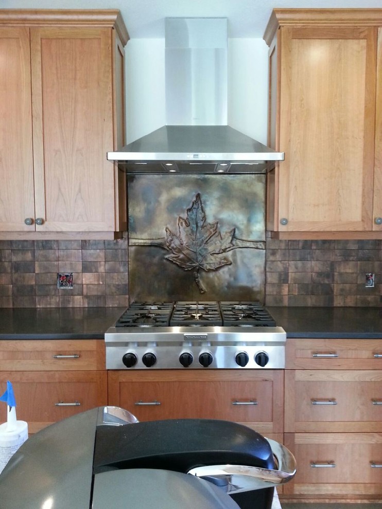 Kitchen - mid-sized transitional kitchen idea in Seattle with shaker cabinets, light wood cabinets, granite countertops, metallic backsplash and metal backsplash