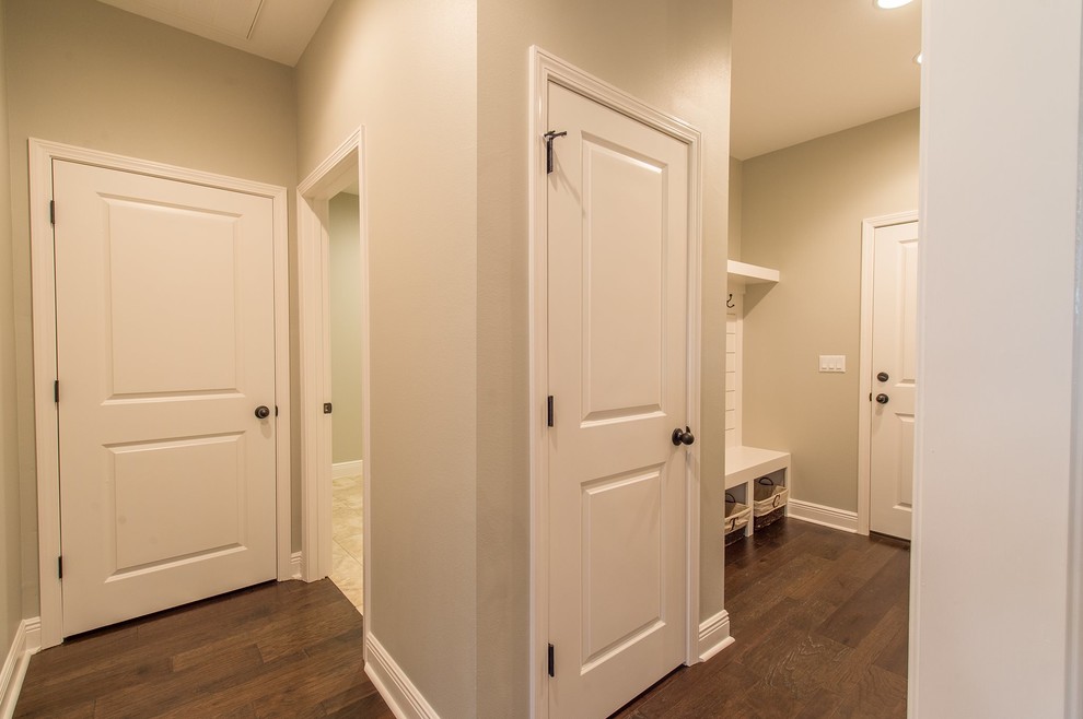 Mid-sized transitional dark wood floor mudroom photo in Miami with beige walls and a white front door