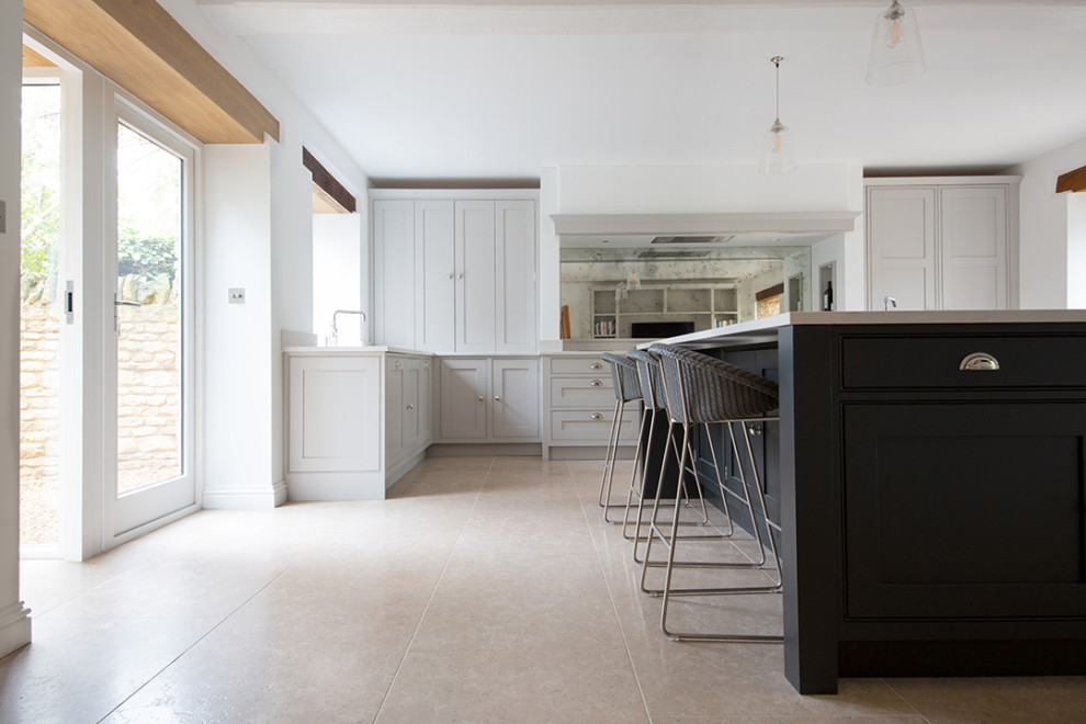This is an example of a large country kitchen in Other with limestone floors and beige floor.