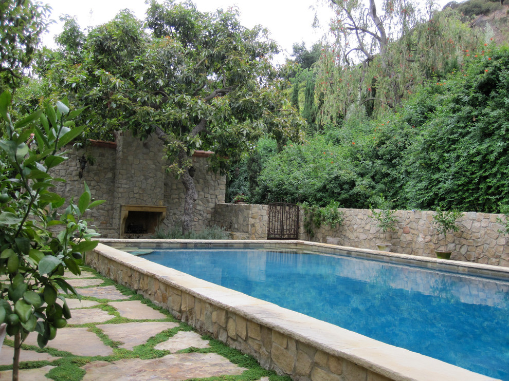 Pool house - large mediterranean backyard stone and rectangular natural pool house idea in New York