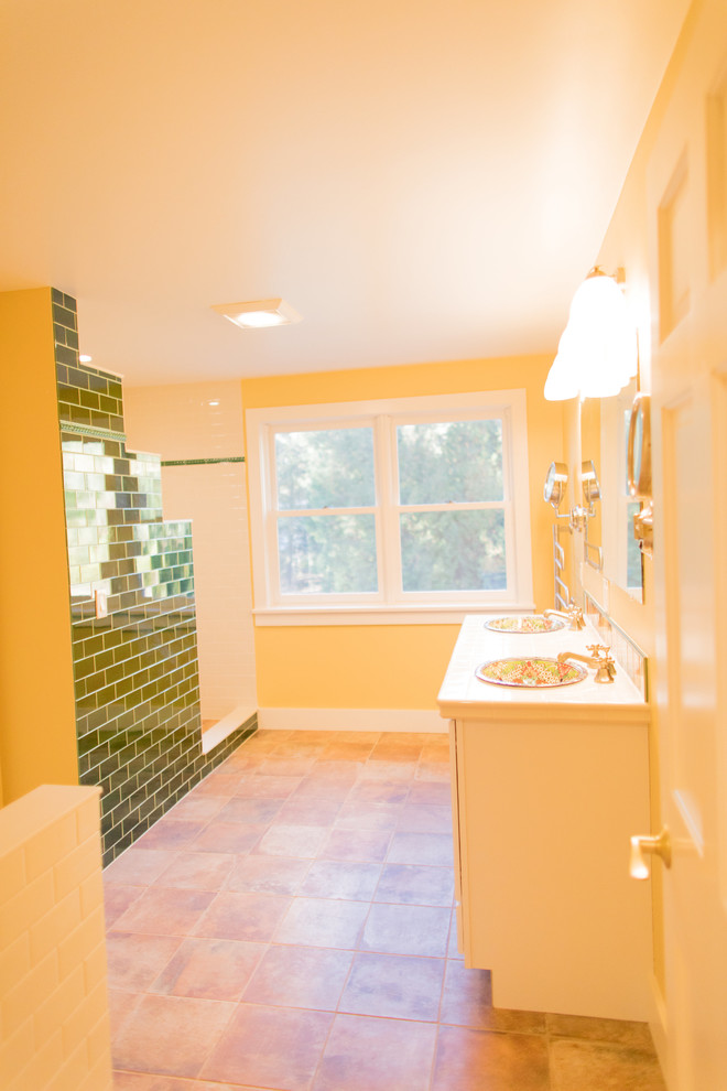 Inspiration for a large mediterranean master bathroom in Boston with white cabinets, a one-piece toilet, white tile, subway tile, yellow walls, terra-cotta floors, a drop-in sink, tile benchtops, red floor and an open shower.