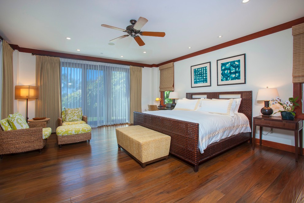 Design ideas for a large beach style master bedroom in Hawaii with dark hardwood floors.