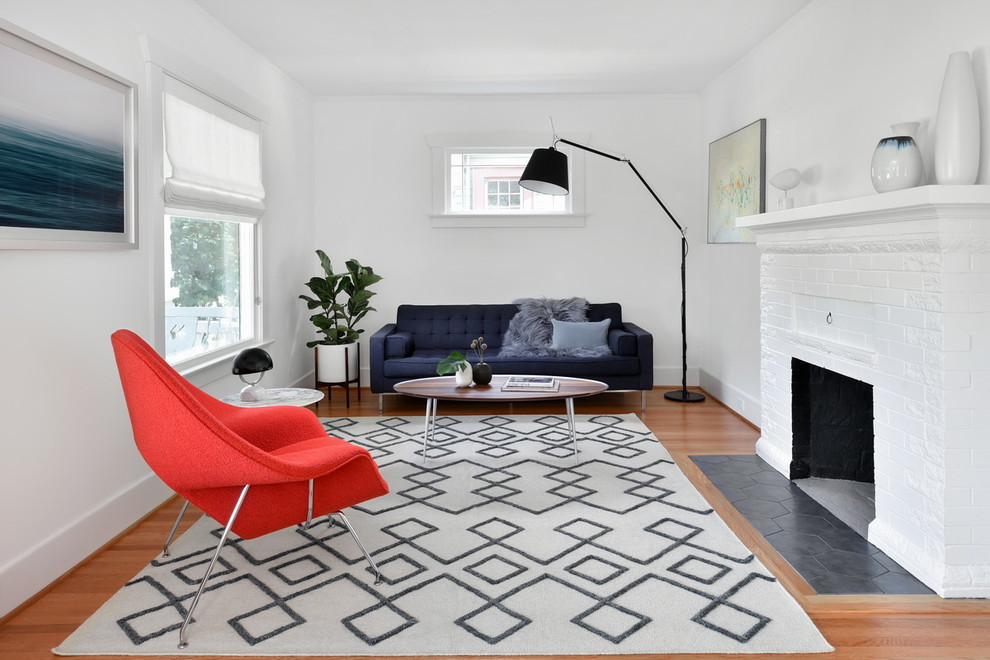 Inspiration for a mid-sized midcentury formal enclosed living room in Los Angeles with white walls, medium hardwood floors, a standard fireplace, a brick fireplace surround, no tv and brown floor.