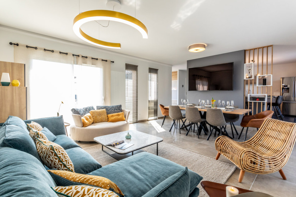 This is an example of a mid-sized contemporary open concept living room in Clermont-Ferrand with white walls, ceramic floors, no fireplace, a wall-mounted tv and grey floor.