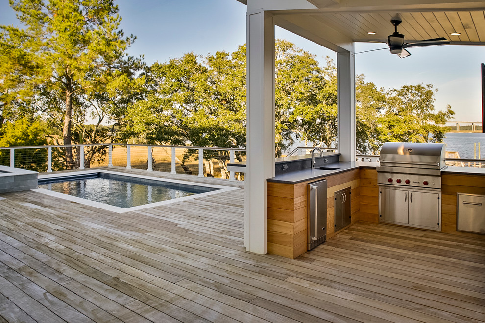 Design ideas for a large modern backyard deck in Charleston with an outdoor shower and a roof extension.