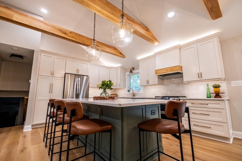 Large transitional l-shaped light wood floor, brown floor and exposed beam eat-in kitchen photo in DC Metro with an undermount sink, shaker cabinets, quartz countertops, white backsplash, porcelain backsplash, stainless steel appliances, an island and white countertops